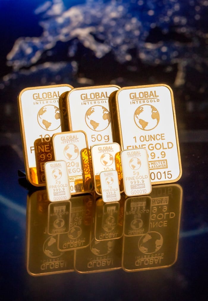 Menu Collection of gold bars featuring a global map and weight inscriptions.
