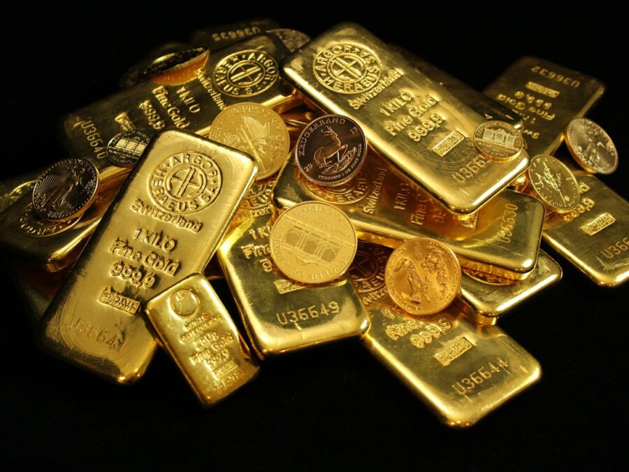 A collection of shining gold bars and coins symbolizing wealth and investment.